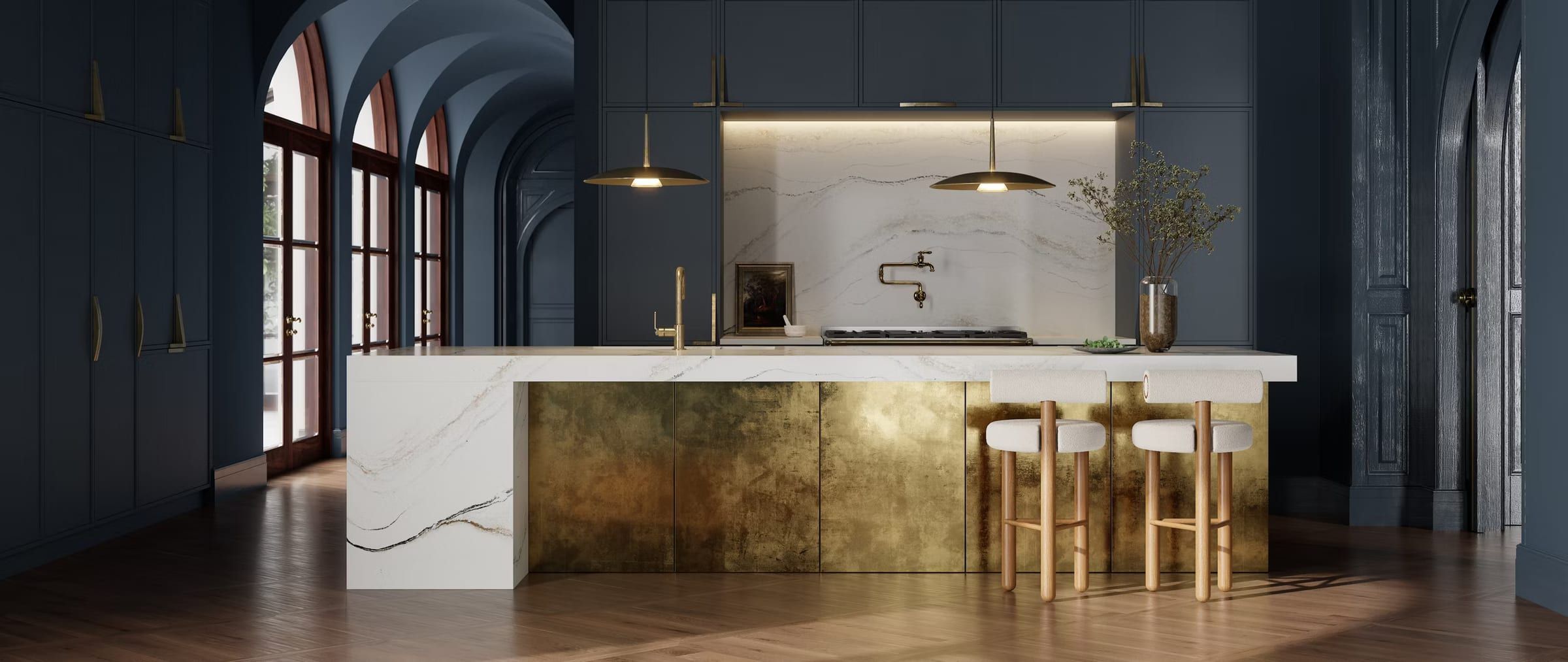 Designer kitchen with dark blue cabinetry, brass accents, and a white Cambria quartz waterfall island with soft grey veining.