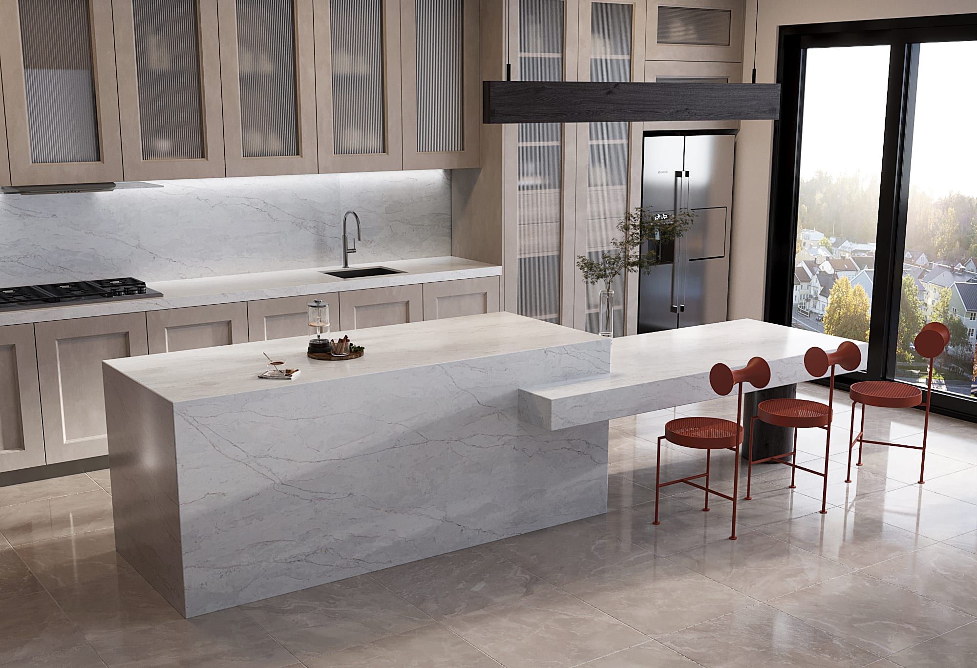 Modern kitchen with beige wood cabinetry and a white Vicostone quartz waterfall island with soft grey veining, next to a matching dining table.